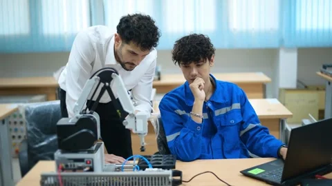 Trainee Robotics engineer learning with Programming and Manipulating Robot Ha Stock Footage 280790289