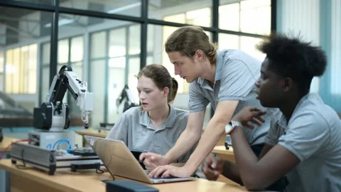Trainee Robotics engineer learning with Programming and Manipulating Robot Ha Stock Footage 280790433