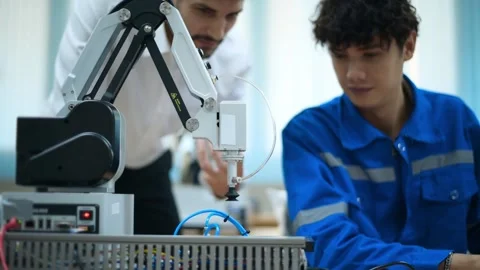 Trainee Robotics engineer learning with Programming and Manipulating Robot Ha Stock Footage 280790434