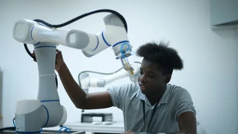 Trainee Robotics engineer learning with Programming and Manipulating Robot Ha Stock Footage 280791031