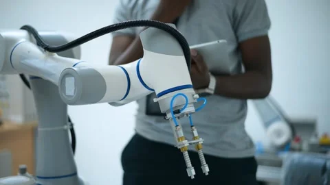 Trainee Robotics engineer learning with Programming and Manipulating Robot Ha Stock Footage 280791058