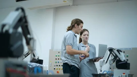 Trainee Robotics engineer learning with Programming and Manipulating Robot Ha Stock Footage 280791078