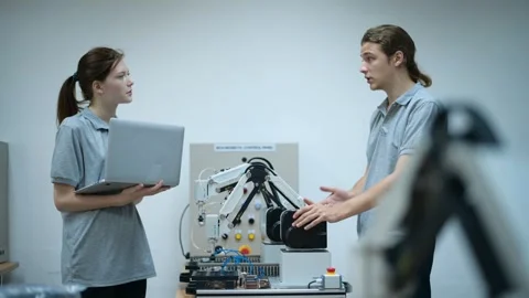 Trainee Robotics engineer learning with Programming and Manipulating Robot Ha Stock Footage 280791084