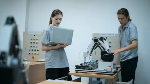 Trainee Robotics engineer learning with Programming and Manipulating Robot Ha Stock Footage 280791091
