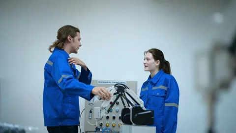 Trainee Robotics engineer learning with Programming and Manipulating Robot Ha Stock Footage 280791103