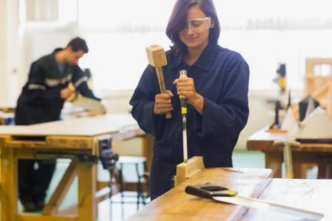 Trainee using mallet and chisel Stock Photos