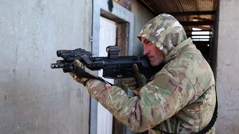 Trainee with Weapon Keeps Aim at Doorway Stock Footage 70561711
