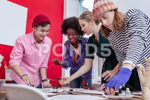 Trainees of fashion department feeling happy while cooperating Stock Photos