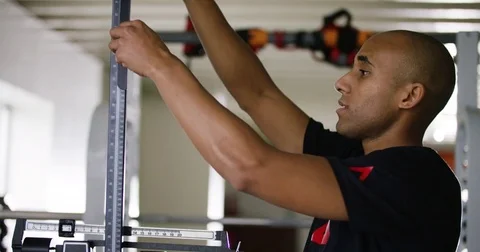 Trainer adjusting portable height measure in fitness studio 動画素材 77335609