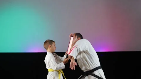 A trainer and a small athlete perform paired exercises Stock Footage 341557438
