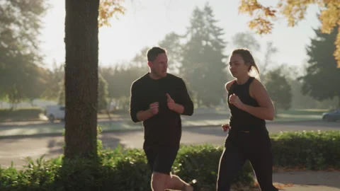 Trainer Clapping for His Client as She Runs on a Cold Day Video stock 210220663