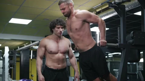 Trainer coaches client in gym. Stock Footage 164614438