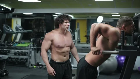 Trainer coaches client in gym. Stock Footage 165829796