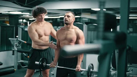 Trainer coaches client in gym. Stock Footage 166562713