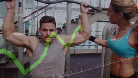 On trainer cue client pulling lat pulldown bar down tracking fitness reps via Stock Footage 330479396