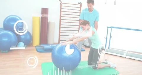 Trainer cueing client kneeling on mat, pushing blue ball while HUD overlays Video stock 330033197