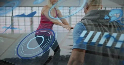 Trainer cueing female trainee performing squat-jump reps in fitness gym, HUD Stock Footage 323407332