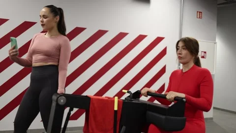 Trainer distracted by smartphone Stock Footage 337115034