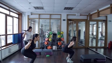 Trainer do exercises with barbell with her group of women in studio Stock Footage 74078329