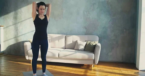 Trainer does exercises with weight plate posing for camera Stockbeeldmateriaal 155778115