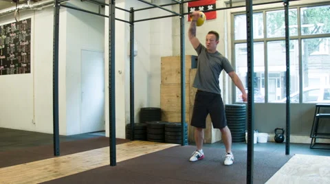Trainer Executing Kettlebell Clean and Jerk Olympic Weightlifting Movement Stock-Footage 40033351