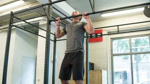 Trainer Executing Strict Pull Ups Body Weight Movement at a CrossFit Box Stock-Footage 40033273