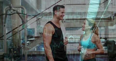Trainer gesturing and trainee nodding, sharing gym tips while translucent chart Video stock 323431675