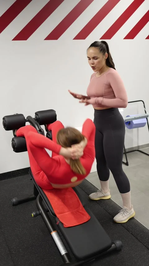 Trainer guides ab exercise Stock Footage 337956683