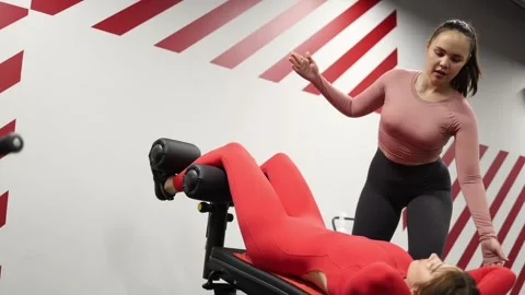 Trainer guides abdominal workout Stock Footage 337114907