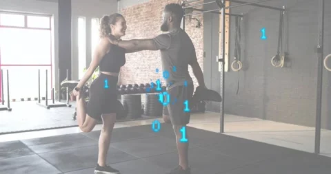 Trainer guiding client leg stretch in gym with binary code, client tapping Vídeos de archivo 318141939