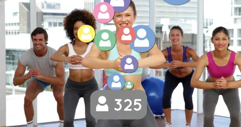 Trainer guiding workout class squatting on Bosu trainers, showing follower count Stock Footage 312017992