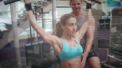 Trainer hand cueing as trainee pulling pulldown bar down, returning up, Stock Footage 333336391