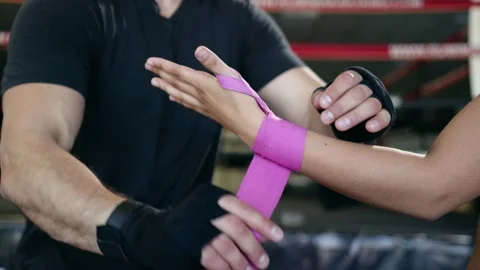 Trainer help woman to put on hand protective bandage before fight. Stock Footage 155609672