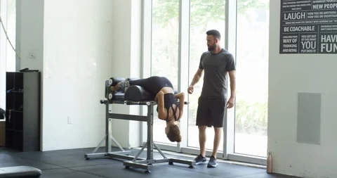 Trainer helping a female athlete workout 스톡 동영상 96911202