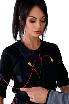 Trainer helps attaching ems Stock Photos