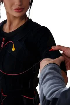 Trainer helps attaching ems Stock Photos