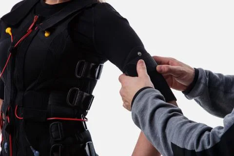 Trainer helps attaching ems Stock Photos