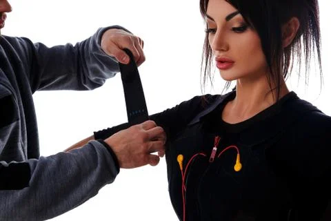 Trainer helps attaching ems Stock Photos