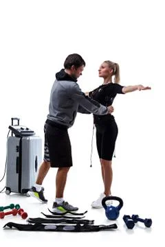 Trainer helps attaching ems Stock Photos