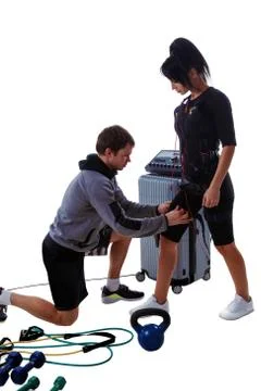 Trainer helps attaching ems Stock Photos