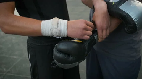 Trainer puts on boxing gloves for sparring in boxing. Sports, discipline Stock Footage 141325488