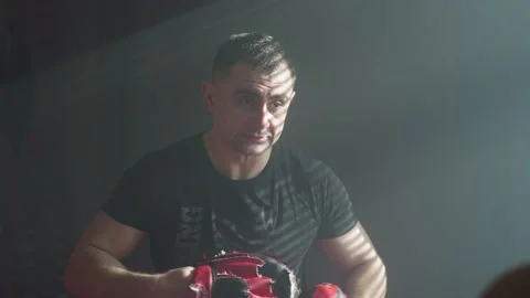 Trainer puts on paws for boxing training in gym. Stock Footage 237434939