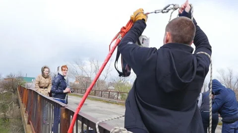 Trainer raises equipment on a rope Stock Footage 68349337