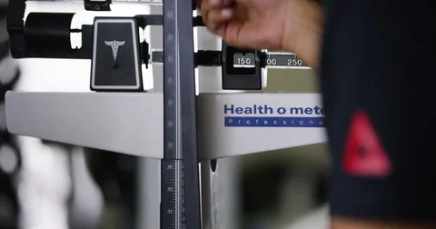 Trainer removing measuring scale from portable height measure in fitness studio 動画素材 77333453