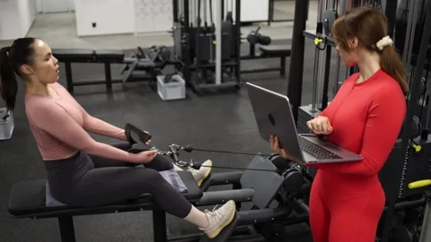 Trainer reviews workout data during session Stock Footage 337114606