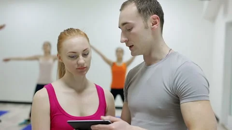 Trainer show training program for girl on tablet Stock Footage 46171651