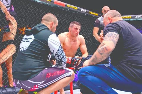 Trainer is showing to the fighter some tricks for winning in the fighting Stock Photos