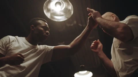 Trainer showing some tricks to the boxer in the locker room Stock Footage 282988853