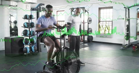 Trainer signaling, client mounting and pedaling airbike, trainer monitoring Stock Footage 334308079