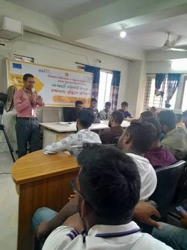 Trainer speaking between his participant persons. Stock Photos